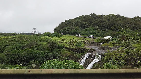 Three Cars in series travelling to Lonavala Hills, Maharashtra in Monsoon